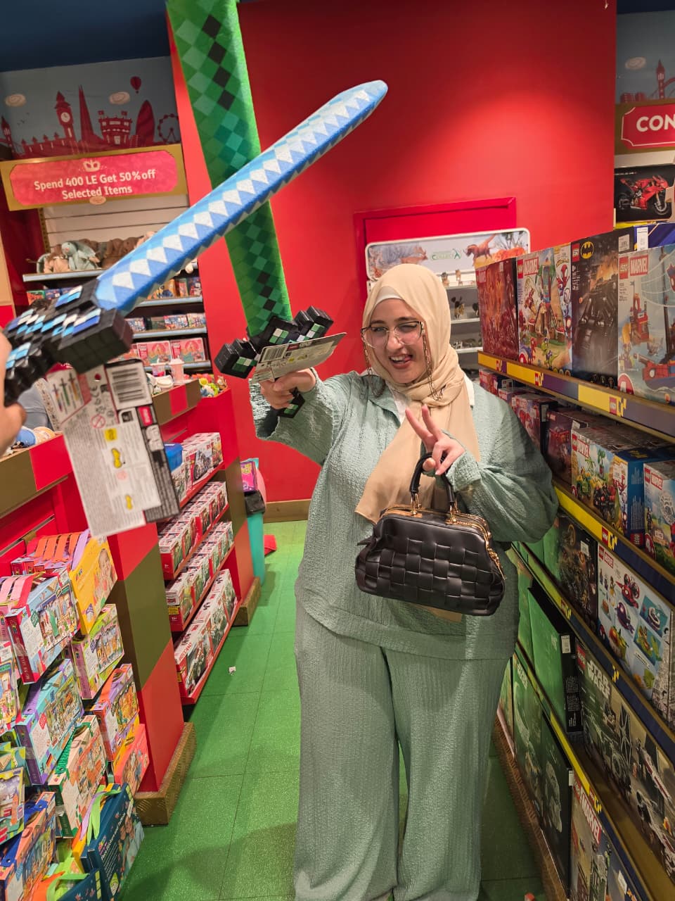 Touqa holding a toy sword during a playful sword fight